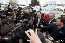 FILE - Members of the media gather around Republican presidential candidate Sen. Ted Cruz of Texas before a campaign event at King's Christian Bookstore in Boone, Iowa, Jan. 4, 2016.