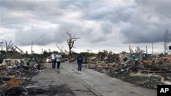 Residents search through what is left of their homes after a tornado hit Pleasant Grove west of downtown Birmingham , Alabama, a day earlier, Apr 28 2011