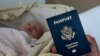 In this photo taken on Jan. 24, 2019, Denis Wolok, the father of 1-month-old Eva, shows the child's U.S. passport during an interview with The Associated Press in Hollywood, Fla. 