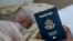 In this photo taken on Jan. 24, 2019, Denis Wolok, the father of 1-month-old Eva, shows the child's U.S. passport during an interview with The Associated Press in Hollywood, Fla. 