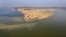 In this Tuesday, April 21, 2020, photo, deserted banks of the Sangam, the confluence of the rivers Ganges and Yamuna are seen during lockdown to control the spread of the coronavirus in Prayagraj, India. India’s extended lockdown to curb the…