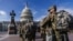 FILE - National Guard troops reinforce security around the U.S. Capitol ahead of expected protests leading up to Joe Biden's inauguration as president, in Washington, Jan. 17, 2021.