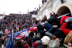 FILE - Pro-Trump protesters storm into the U.S. Capitol during a rally to contest the certification of the 2020 U.S. presidential election results by the U.S. Congress, in Washington, January 6, 2021.