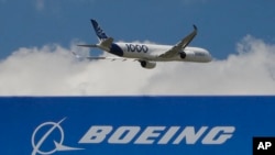 In this June 17, 2019, file photo, an Airbus A 350 - 1000 performs a demonstration flight at Paris Air Show in Le Bourget, east of Paris, France.(AP Photo/Michel Euler, FILE) 