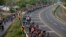 FILE - Central American migrants, part of the caravan hoping to reach the U.S. border, walk in Frontera Hidalgo, Mexico, April 12, 2019.