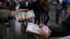 Iranian street money exchangers show currencies at Tehran's old main bazaar, Iran, Nov. 25, 2014.