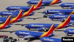FILE - A number of grounded Southwest Airlines Boeing 737 MAX 8 aircraft are shown parked at Victorville Airport in Victorville, California, March 26, 2019.