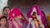 FILE - An underaged bride, right, stands with family members during her marriage at a Hindu temple near Rajgarh, Madhya Pradesh state, India, April 17, 2017.