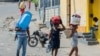 People flee their neighborhood after armed gangs terrorized the Delmas 24 and Solino areas, in Port-au-Prince, Haiti, Oct. 20, 2024. 