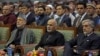 FILE - Afghan President Ashraf Ghani, center, former President Hamid Karzai, left, and Afghan chief executive Abdullah Abdullah, right, attend during a ceremony marking the first anniversary of the death of Former Afghan Vice President Marshal Mohammed Qa