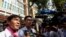 FILE: Uon Chhin and Yeang Sothearin, former journalists from the U.S.-funded Radio Free Asia (RFA), who have been charged with espionage, speak to the media in front of the Municipal Court of Phnom Penh, Cambodia, Oct. 3, 2019. (Reuters)