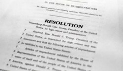 A copy of a page of the Articles of Impeachment is seen in Washington, Dec. 10, 2019.