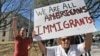 Protesters chant outside the Grayson County courthouse in Sherman, Texas, Feb. 16, 2017. In an action called "A Day Without Immigrants," immigrants across the country are expected to stay home from school, work and close businesses to show how critical they are to the U.S. economy and way of life. 