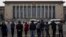 People watch as police officers check visitors in front of the Great Hall of the People during a gathering of the 205-member Central Committee's third annual plenum in Beijing, China, Nov. 9, 2013.