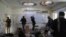 FILE - Journalists photograph inside Kabul University after a deadly attack in Kabul, Afghanistan, Nov. 3, 2020.