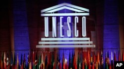 FILE - In this Nov.4, 2017 file photo, the logo of the United Nations Educational, Scientific and Cultural Organisation (UNESCO) is seen during the 39th session of the General Conference at the UNESCO headquarters in Paris. (AP Photo/Christophe Ena, File)