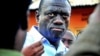 Ugandan opposition leader Kizza Besigye speaks to journalists in the yard outside his house shortly after returning home after a confrontation with police, in Kasangati, Uganda, May 19, 2011 (file photo)