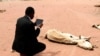As drought grips the Horn of Africa, an aid worker films the rotting carcass of a cow with in iPad near the Kenya-Somalia border, July 23, 2011. (Reuters)