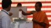 Cambodian Buddhist monk, right, casts his ballot in local elections at Wat Than pagoda's polling station in Phnom Penh, file photo. 