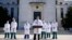 U.S. Navy Commander Dr. Sean Conley, the White House physician, is flanked by other doctors as he speaks to the media, at Walter Reed National Military Medical Center in Bethesda, Maryland, Oct. 4, 2020.