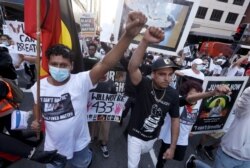 FILE - Protesters march in Sydney, June 6, 2020, to support U.S. protests over the death of George Floyd. Thousands of demonstrators in state capitals honored Floyd and protested the deaths of indigenous Australians in custody.