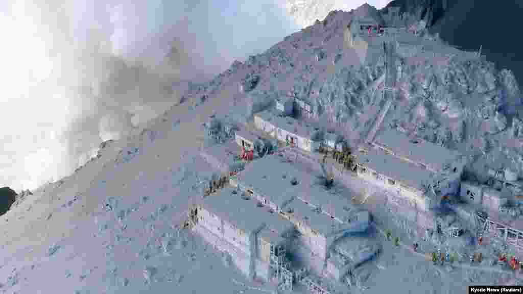 Para anggota Pasukan Bela Diri Jepang (JSDF) dan pemadam kebakaran memimpin operasi penyelamatan di pondok-pondok gunung yang tertutup abu vulkanik di dekat puncak Gunung Ontake,&nbsp;yang terbentang di antara wilayah Nagano dan Gifu (28/9). 