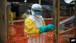 FILE - An Ebola health worker is seen at a treatment center in Beni, Eastern Congo, April, 16, 2019. 