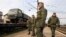 Russian servicemen stand in front of a military truck on a freight carriage near the Crimean city of Simferopol April 1, 2014. NATO says it will explore all options to boost the alliance&#39;s defenses after seeing no signs of a Russian troop withdrawal.on Tu