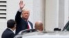 Republican presidential candidate Donald Trump waves as he arrives for a meeting with House Speaker Paul Ryan of Wis., at the Republican National Committee Headquarters on Capitol Hill in Washington, May 12, 2016. 