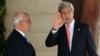 US Secretary of State John Kerry (R) waves to the media as he stands next to Palestinian Chief of Negotiator Saeb Erekat upon his arrival for a meeting with Palestinian president Mahmoud Abbas in the West Bank city of Ramallah on May 23, 2013.