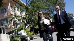 Oxfam International Regional Director for Latin America, Simon Ticehurst, and Oxfam Intermon Executive Affiliate Unit head, Margalida Massot, leave after a meeting with Haiti's Minister of Planning and External Cooperation Aviol Fleurant in Port-au-Prince