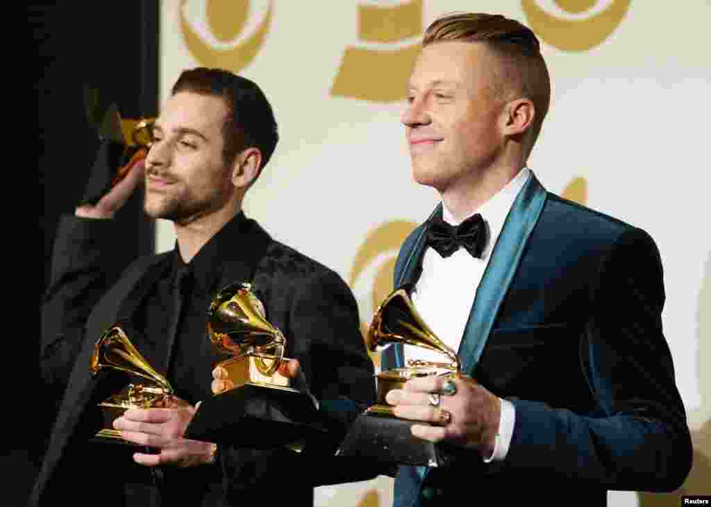 Macklemore and Ryan Lewis pose backstage with their awards for best new artist, best rap performance for "Thrift Shop", best rap song for "Thrift Shop", and best rap album for "The Heist" at the 56th annual Grammy Awards in Los Angeles, Jan. 26, 2014.