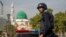 A Pakistani police officer stands guard outside the Barri Imam shrine, as security is beefed up in the capital following a suicide attack at a Sufi shrine in interior Sindh, Islamabad, Pakistan, Feb. 17, 2017.
