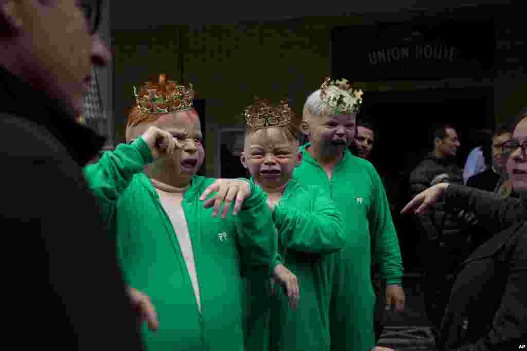Representatives from a betting company wear baby masks outside St. Mary&#39;s Hospital in London, July 12, 2013.