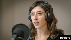 Italian journalist Cecilia Sala, who was arrested by police in Tehran, Dec. 9, 2024, according to Italy's foreign ministry, records her podcast 'Stories' at her home in Rome, in this undated picture released by Chora Media/via Reuters. 