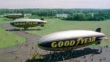 In this June 18, 1998 file photo, three Goodyear blimps, the then newly commissioned Stars and Stripes, foreground, the decommissioned Stars and Stripes, middle, and the Spirit of Akron are moored at the Goodyear blimp base in Suffield, Ohio. (AP Photo/Jeff Glidden)