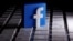 A 3D-printed Facebook logo is seen placed on a keyboard in this illustration taken March 25, 2020.