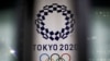 FILE - The logo of Tokyo 2020 Olympic Games, that have been postponed to 2021 due to the coronavirus outbreak, is seen through signboards, at Tokyo Metropolitan Government Office building in Tokyo, Japan, Jan. 22, 2021. 