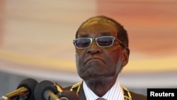 FILE: President Robert Mugabe waits to address crowds gathered for Zimbabwe's Heroes Day commemorations in Harare, August 10, 2015.
