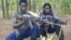Fighters loyal to the Lord's Resistance Army (LRA) pose with their rifles inside the forest near River Mbou in the Central African Republic (CAR) in this handout picture dated April 4, 2012. 