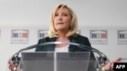 FILE - President of the French far-right party Rassemblement National (National Rally) and MP Marine Le Pen gives a press conference, in Paris, March 9, 2021. 