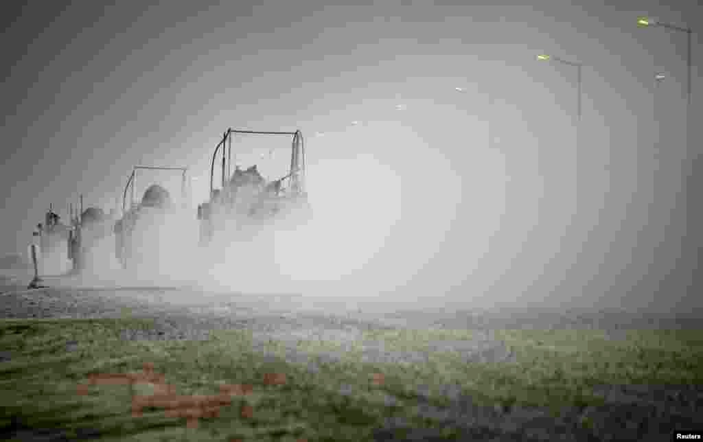 U.S. Mine Resistant Ambush Protected (MRAP) vehicles drive through Camp Adder before departing Imam Ali Base near Nasiriyah, Iraq, Dec. 16, 2011. 