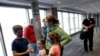 FILE - People wearing masks wait to board a flight in Kansas City, Missouri, May 24, 2020. Governments and businesses are scrambling to change course following new federal guidance calling for the return of mask wearing in virus hot spots.