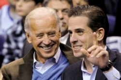 FILE - Then-U.S. Vice President Joe Biden and his son Hunter Biden attend a basketball game in Washington, Jan. 30, 2010.