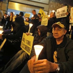 Protesters hold a candlelight vigil outside the China Liaison Office in Hong Kong in support of the Wukan villagers in December.