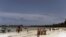 Local tourists walk at the Kenyatta public beach on August 30, 2012, in Mombasa, Kenya.