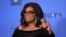 Oprah Winfrey poses in the press room with the Cecil B. DeMille Award at the 75th annual Golden Globe Awards 