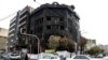 Traffic passes a building that was set ablaze during recent protests in Tehran, Nov. 20, 2019. 