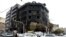 Traffic passes a building that was set ablaze during recent protests in Tehran, Nov. 20, 2019. 
