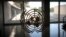 FILE - The United Nations logo is seen on a window in an empty hallway at United Nations headquarters in New York.